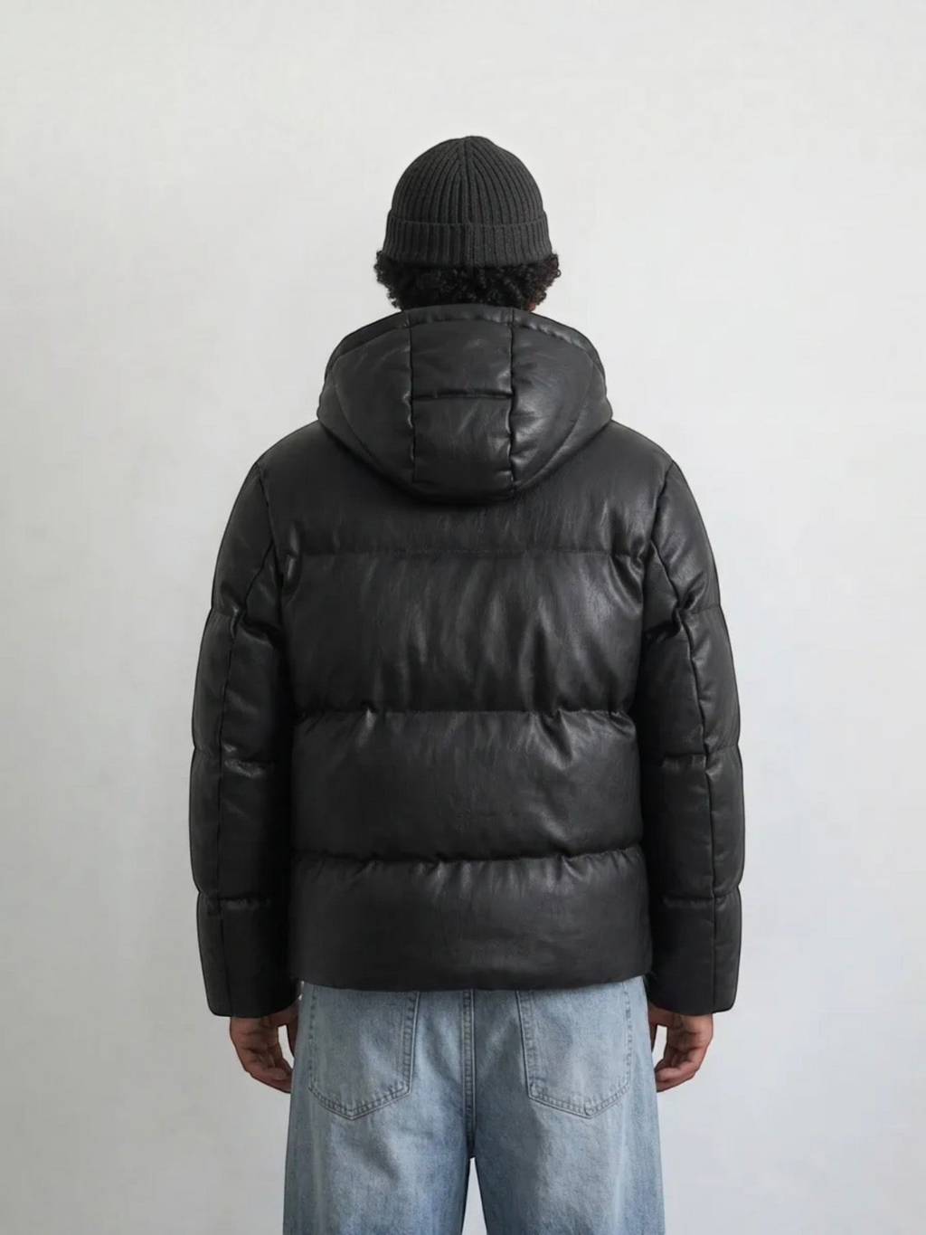BROCK men's black hooded puffer jacket in a leather-look finish, worn by a man in a beanie, back view.