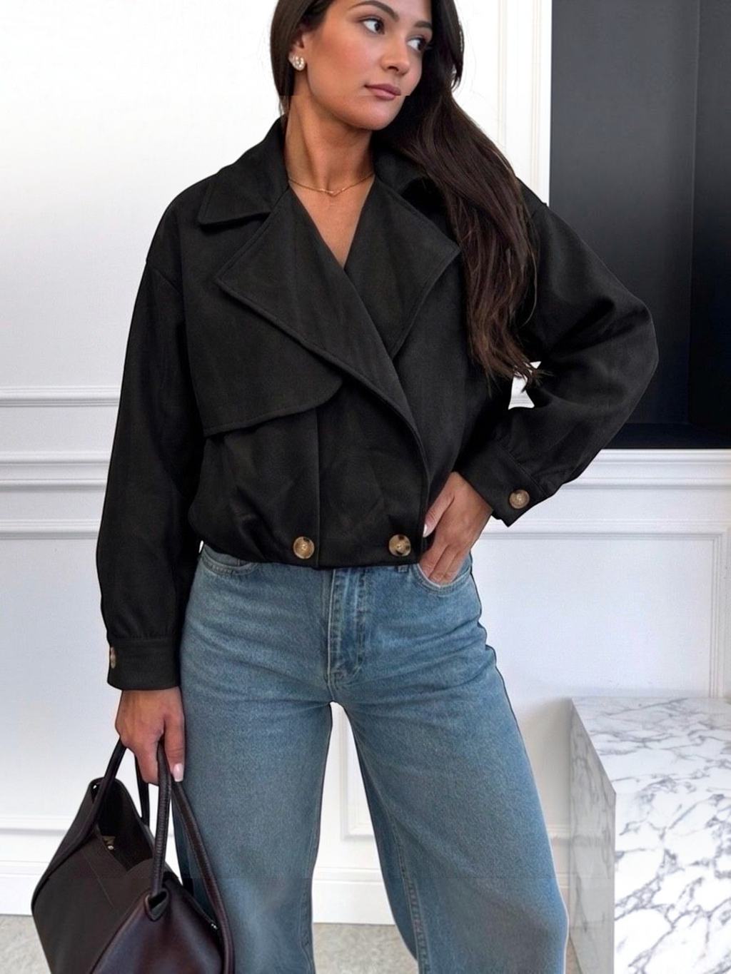 BROCK ESTEE BROWN black faux suede cropped jacket with wide lapels and button details worn with blue jeans