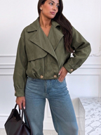 BROCK ESTEE BROWN olive green faux suede cropped jacket with wide lapels and button cuffs worn with blue jeans