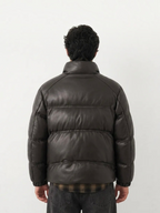 Back view of a man wearing a BROCK dark brown faux leather puffer jacket with a high collar and quilted design.