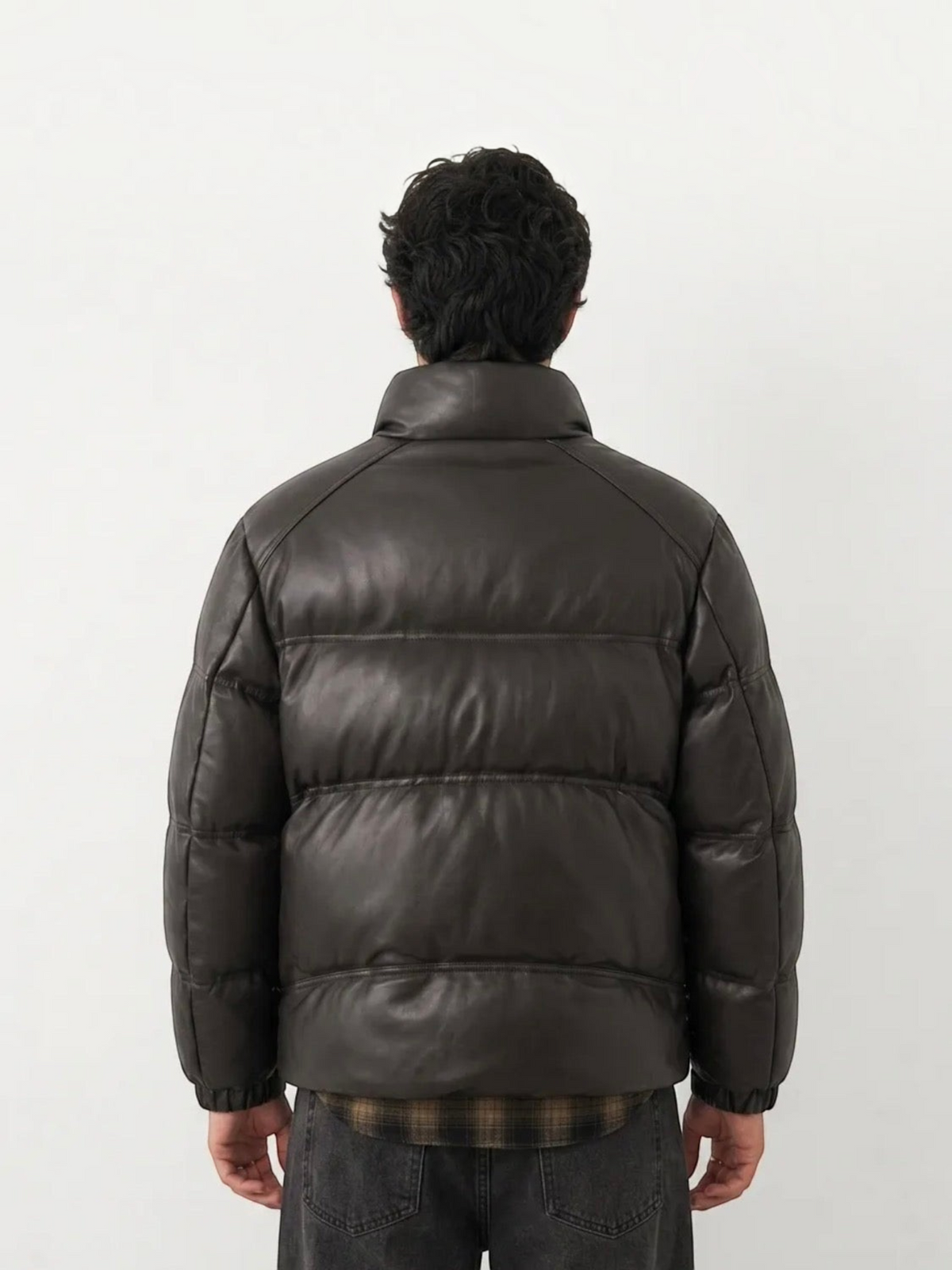 Back view of a man wearing a BROCK dark brown faux leather puffer jacket with a high collar and quilted design.