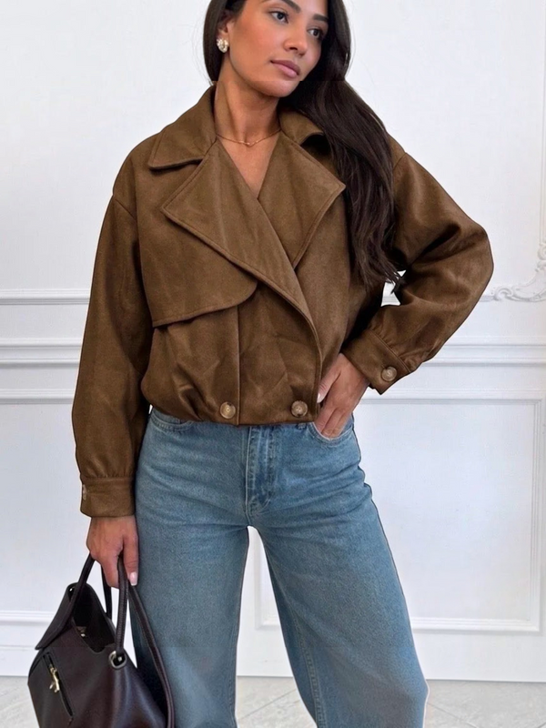 BROCK ESTEE BROWN cropped brown suede jacket with wide lapels and button cuffs worn with blue jeans