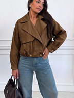 BROCK ESTEE BROWN cropped brown suede jacket with wide lapels and button cuffs worn with blue jeans