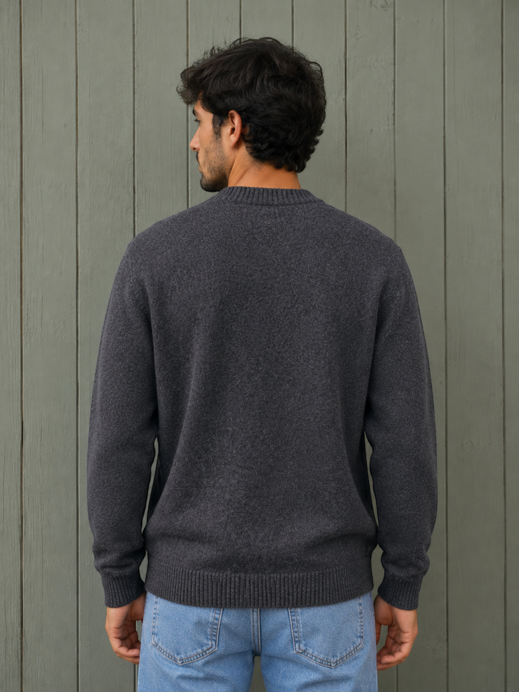 Man wearing a grey KZ DIFFUSION wool blend sweater, back view, against a wooden wall.