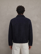 BROCK navy blue textured short jacket worn by a man, back view, featuring a structured fit and polyester fabric.