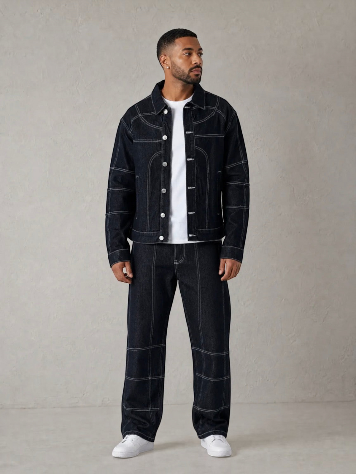 BROCK blue denim two-piece set with contrast stitching worn by a man with a white t-shirt and sneakers