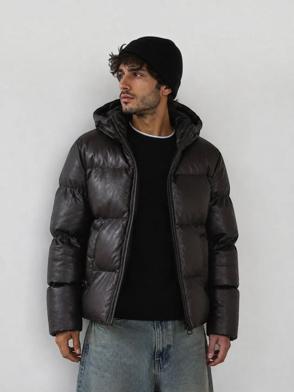 BROCK men's black hooded puffer jacket in a faux leather finish worn by a model with a black beanie