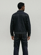 BROCK dark denim two-piece set featuring a structured jacket and cargo pants with contrast stitching, back view.