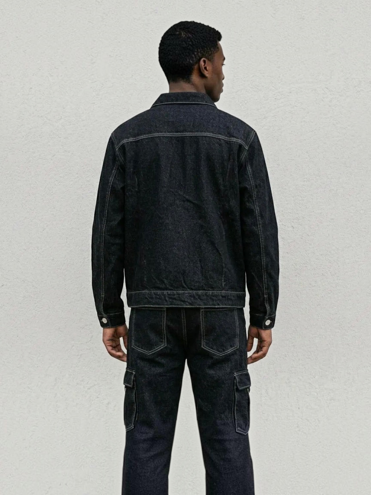 BROCK dark denim two-piece set featuring a structured jacket and cargo pants with contrast stitching, back view.