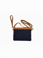 BROCK LOUISA LEE navy blue raffia clutch with tan leather trim, wrist strap, and adjustable shoulder strap.