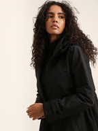 Model wearing a black BROCK long waterproof hooded jacket with a lightweight lining and adjustable hood.