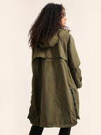 BROCK ATTRAIT PARIS olive green long waterproof hooded jacket with side zippers worn by a woman from the back