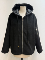 BROCK black felted wool blend zip-up jacket with a quilted hood, drawstring, and utility sleeve pocket on a mannequin