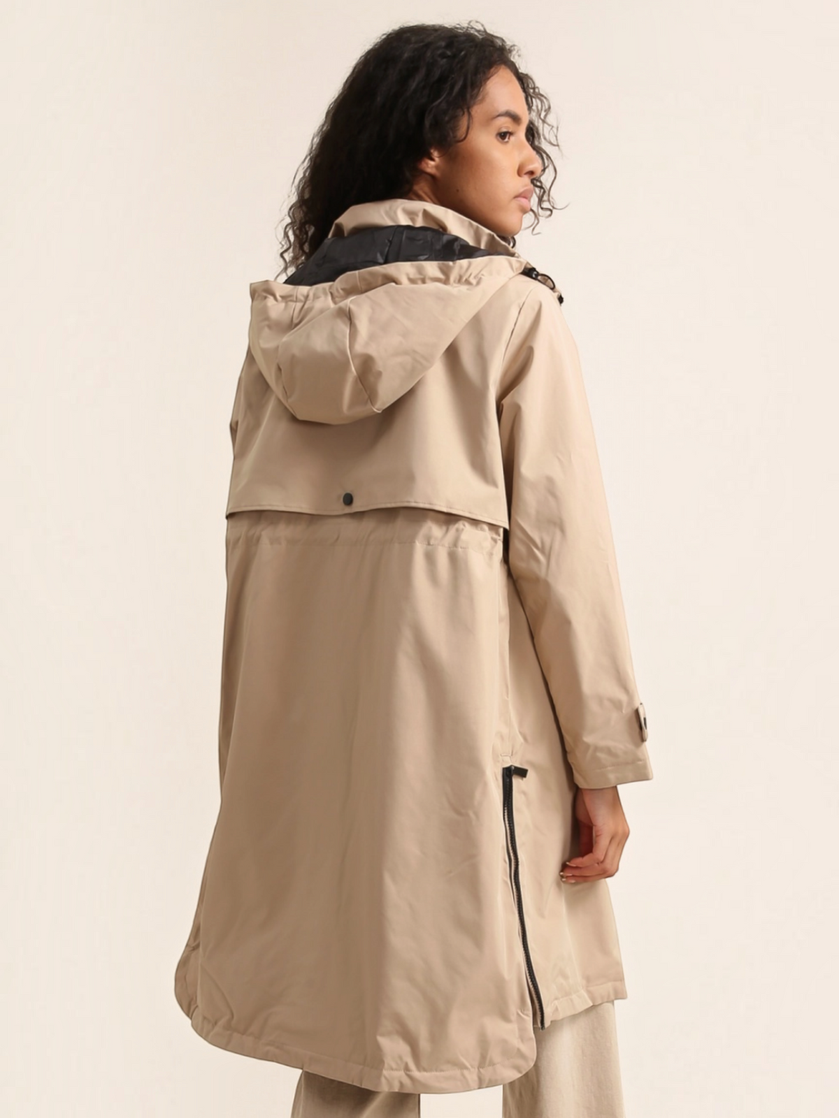BROCK ATTRAIT PARIS beige long waterproof hooded jacket with back vent detail worn by a model
