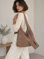 Model wearing a BROCK INES DELAURE brown suede leather hobo bag with a matching mini pouch over her shoulder