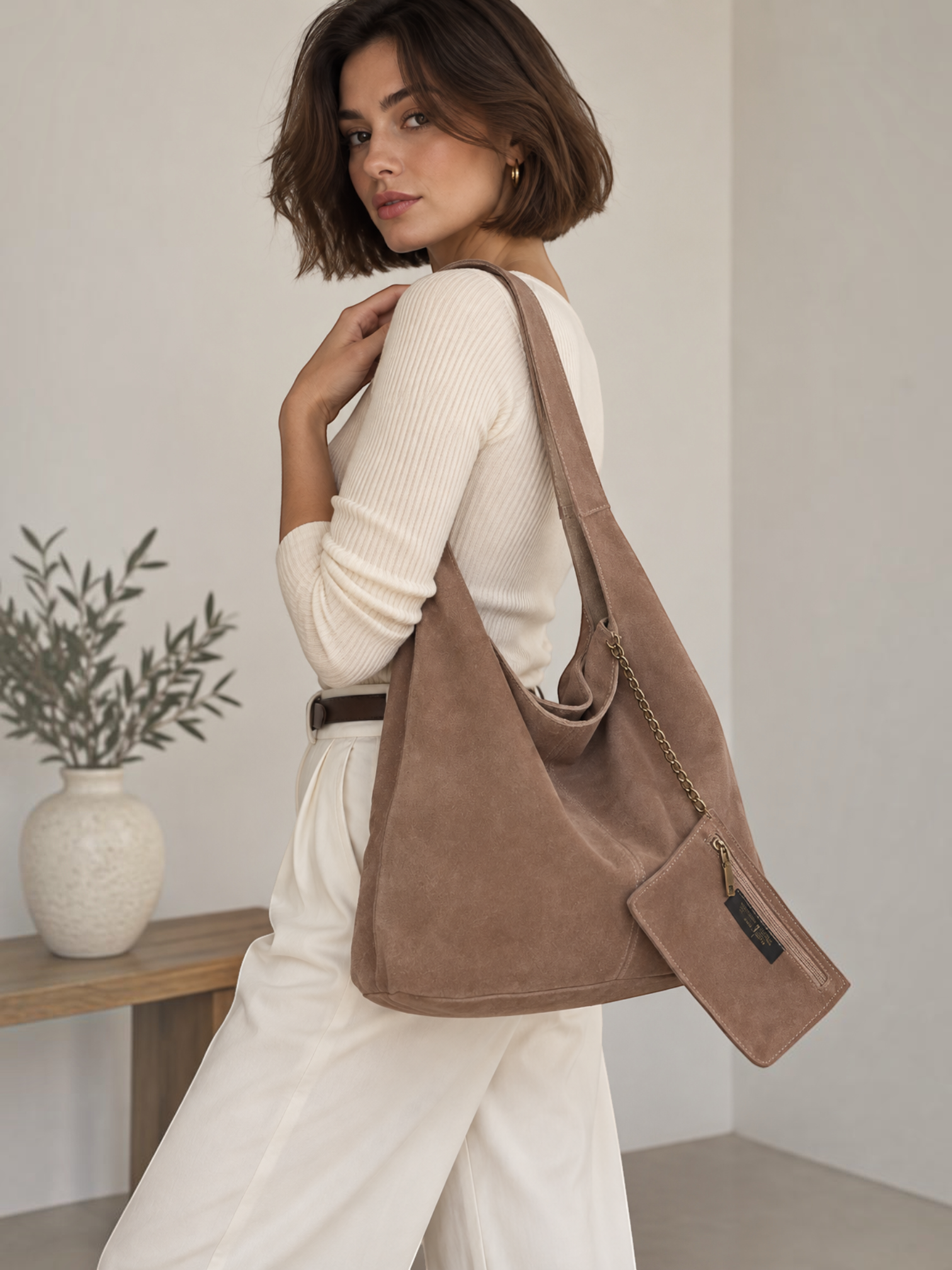Model wearing a BROCK INES DELAURE brown suede leather hobo bag with a matching mini pouch over her shoulder