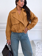 Woman wearing a BROCK ESTEE BROWN tan suede-effect polyester jacket with a structured collar and button cuffs.
