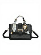 Sac à main noir BROCK GALLANTRY avec motif monogramme, fermoir doré et foulard décoratif noué sur la poignée.