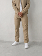 BROCK men's cafe brown two-piece suit set featuring a structured jacket and matching trousers with white sneakers.