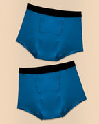 BROCK ANAISSA pack of two blue teen menstrual shorts with black elastic waistbands and absorbent design.