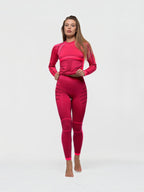 Model wearing BROCK ANAISSA Acro seamless pink compression sportswear set with long sleeves and high-waisted leggings.