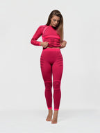Model wearing BROCK ANAISSA Acro seamless pink compression sports set with high-waisted leggings and long-sleeve top.
