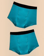 Two BROCK ANAISSA Marie teen menstrual shorts in teal with black waistbands, made from organic cotton and bamboo.