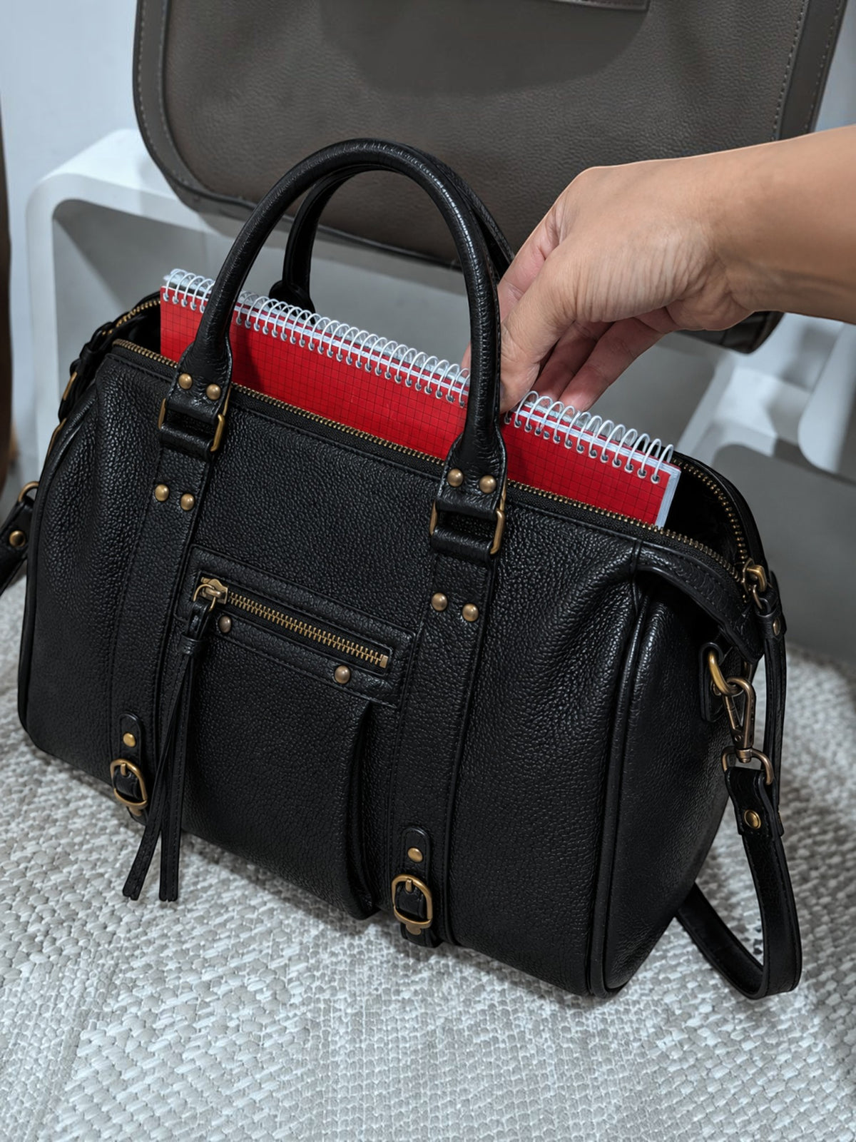 BROCK BAGSTORY black faux leather tote bag with A4 notebook, featuring gold hardware and double handles.
