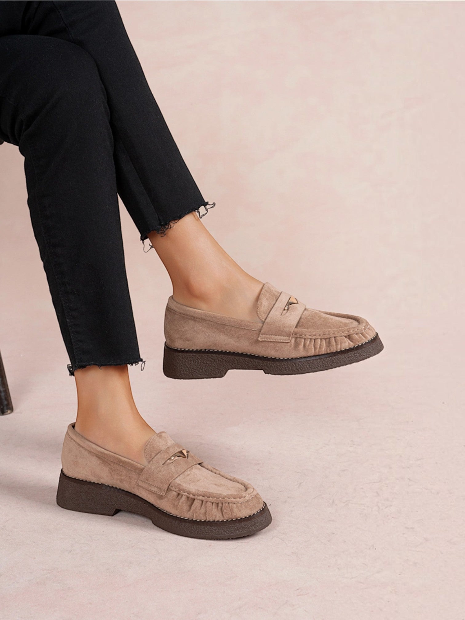 BROCK LADY GLORY beige faux suede loafers with ruched detailing, gold metallic accent, and low block heel on model