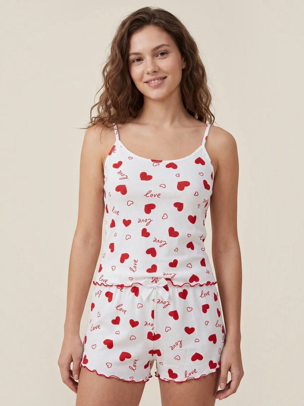 Model wearing BROCK BELLE COM'ELLE white ribbed pajama set with red hearts and love print, featuring camisole and shorts