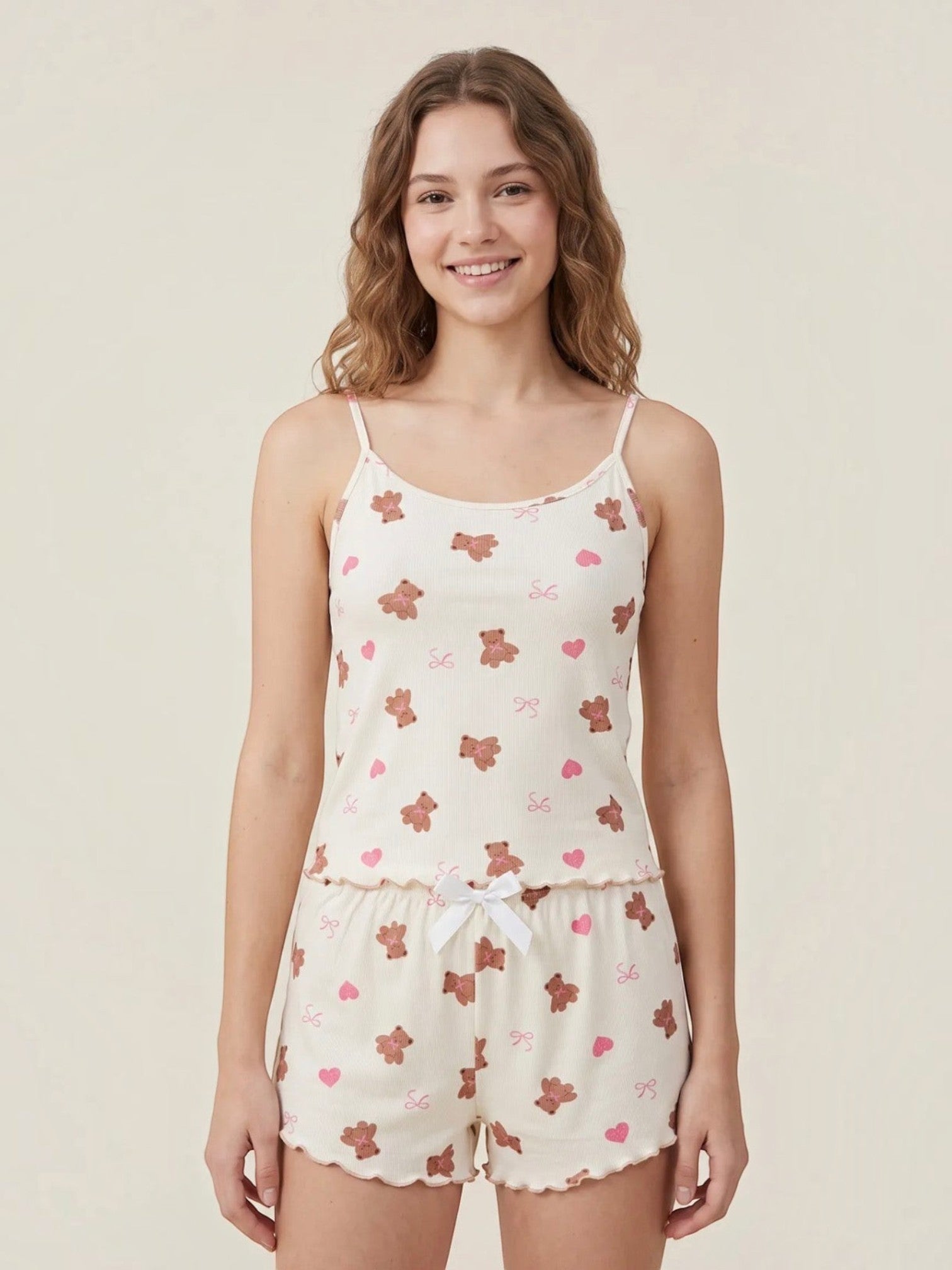 Model wearing a BROCK BELLE COM'ELLE ribbed pajama set with teddy bear and heart print, featuring a camisole and shorts