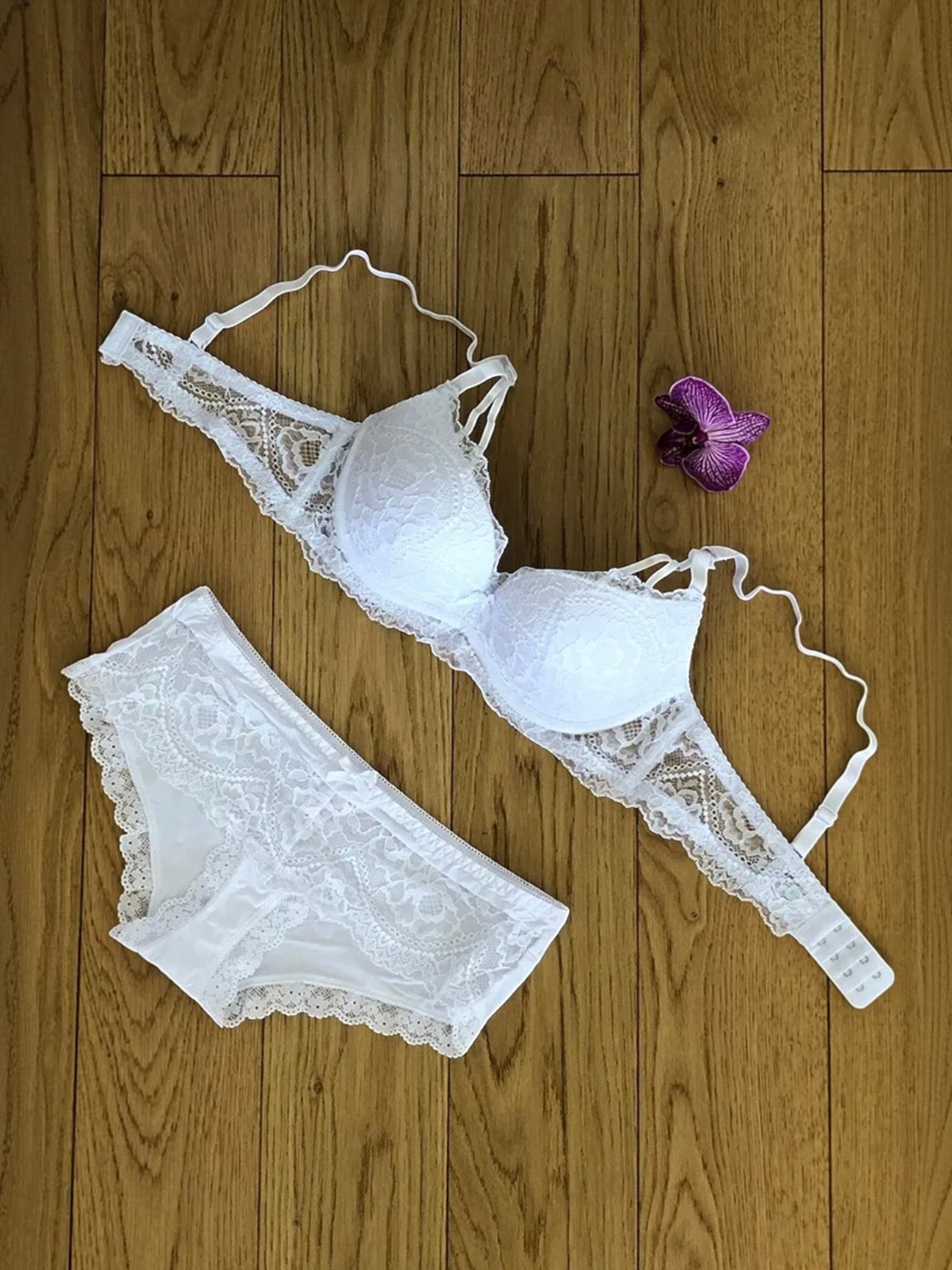 BROCK BELLE COM'ELLE white lace lingerie set with bra and matching panties on a wooden floor