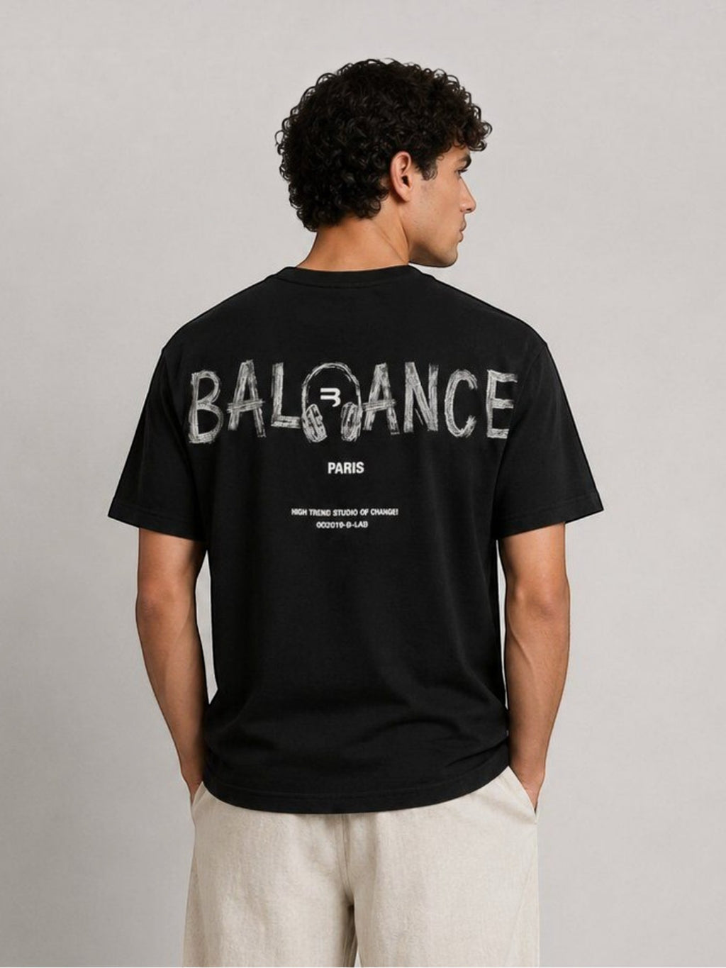 BROCK black cotton t-shirt with white graphic typography print on the back worn by a man