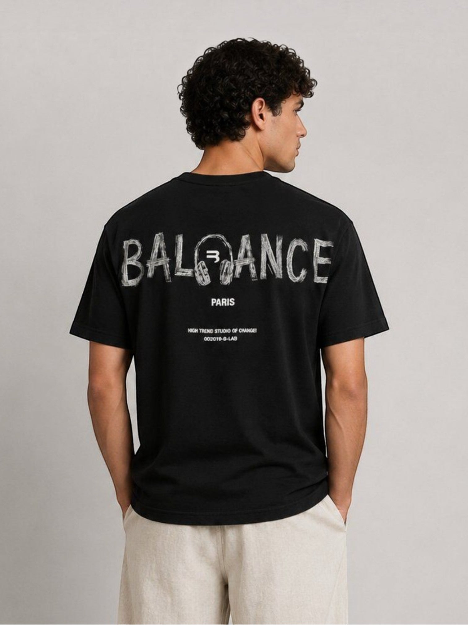 BROCK black cotton t-shirt with white graphic typography print on the back worn by a man