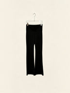 BROCK black high-waisted flared leggings made from polyamide and elastane blend hanging on a hanger