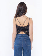 BROCK black lace crop top with built-in bra and strappy back detail worn by a woman with long brown hair