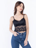 Model wearing a black BROCK lace crop top with built-in cups and thin straps, paired with blue denim jeans.