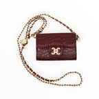 BROCK mini crossbody bag in burgundy faux crocodile leather with a gold chain strap and C.Clo logo detail.