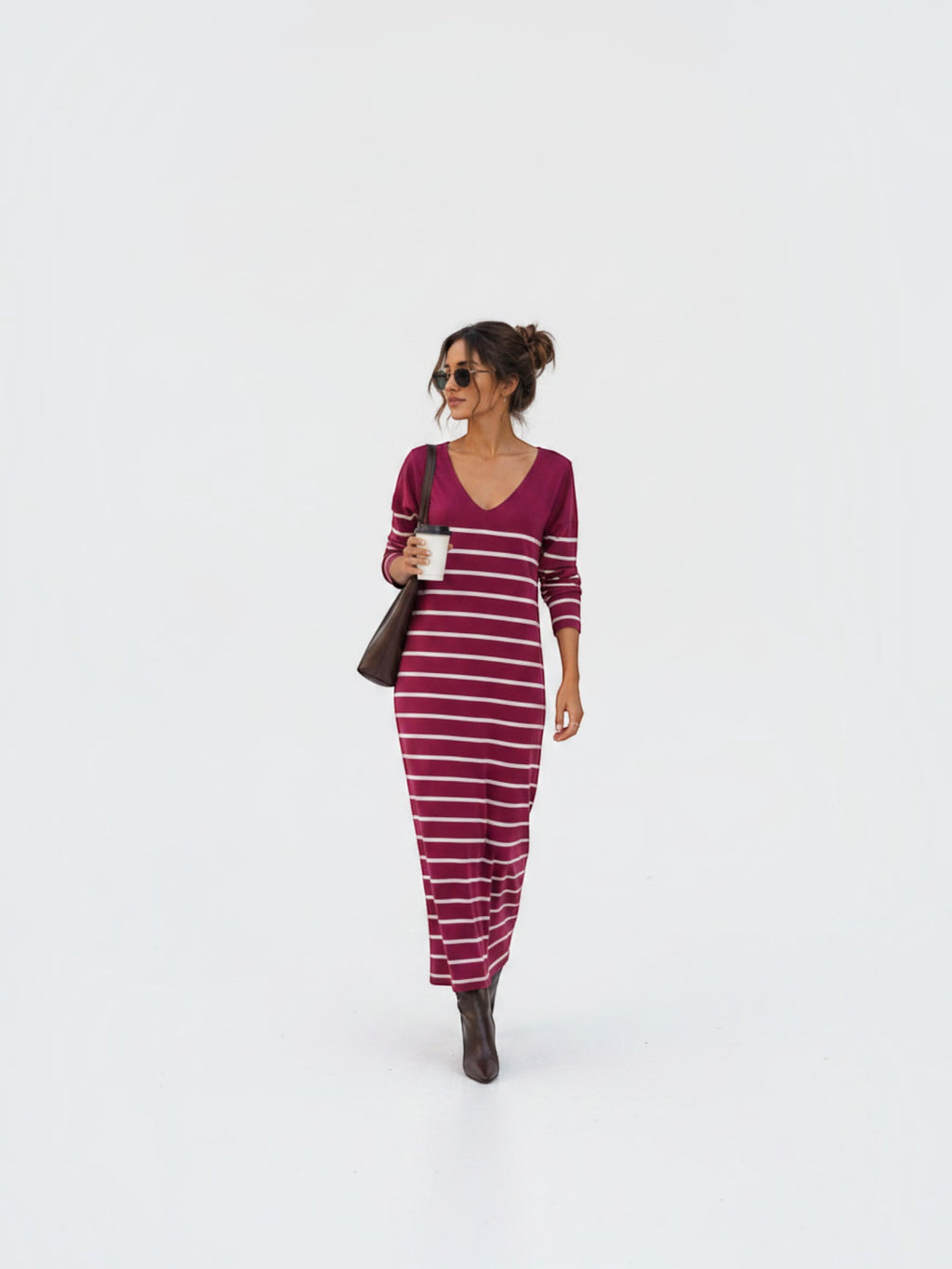 BROCK long striped V-neck maxi dress in burgundy worn by a woman with brown boots and a shoulder bag