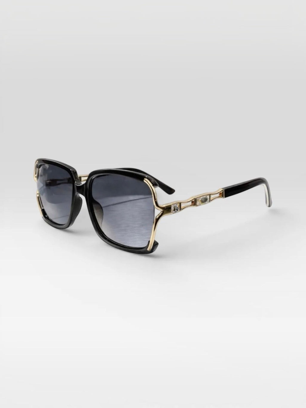 BROCK BYREN | ÉLINE L'ATELIER sunglasses with black square frames, gold accents, and gradient lenses.
