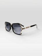 BROCK BYREN | ÉLINE L'ATELIER sunglasses with black square frames, gold accents, and gradient lenses.