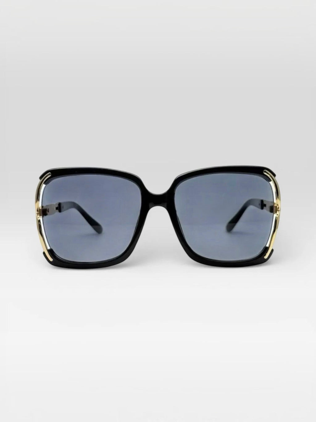 BROCK BYREN | ÉLINE L'ATELIER square sunglasses with black frames and gold metal accents on a light background