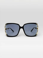 BROCK BYREN | ÉLINE L'ATELIER square sunglasses with black frames and gold metal accents on a light background