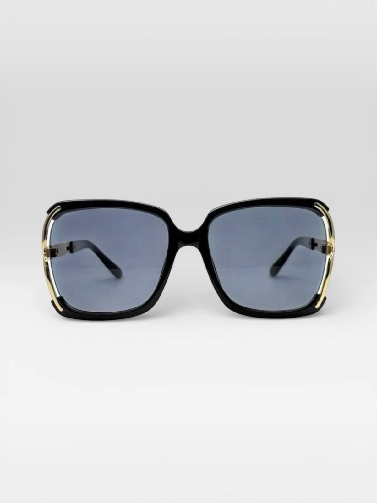 BROCK BYREN | ÉLINE L'ATELIER square sunglasses with black frames and gold metal accents on a light background