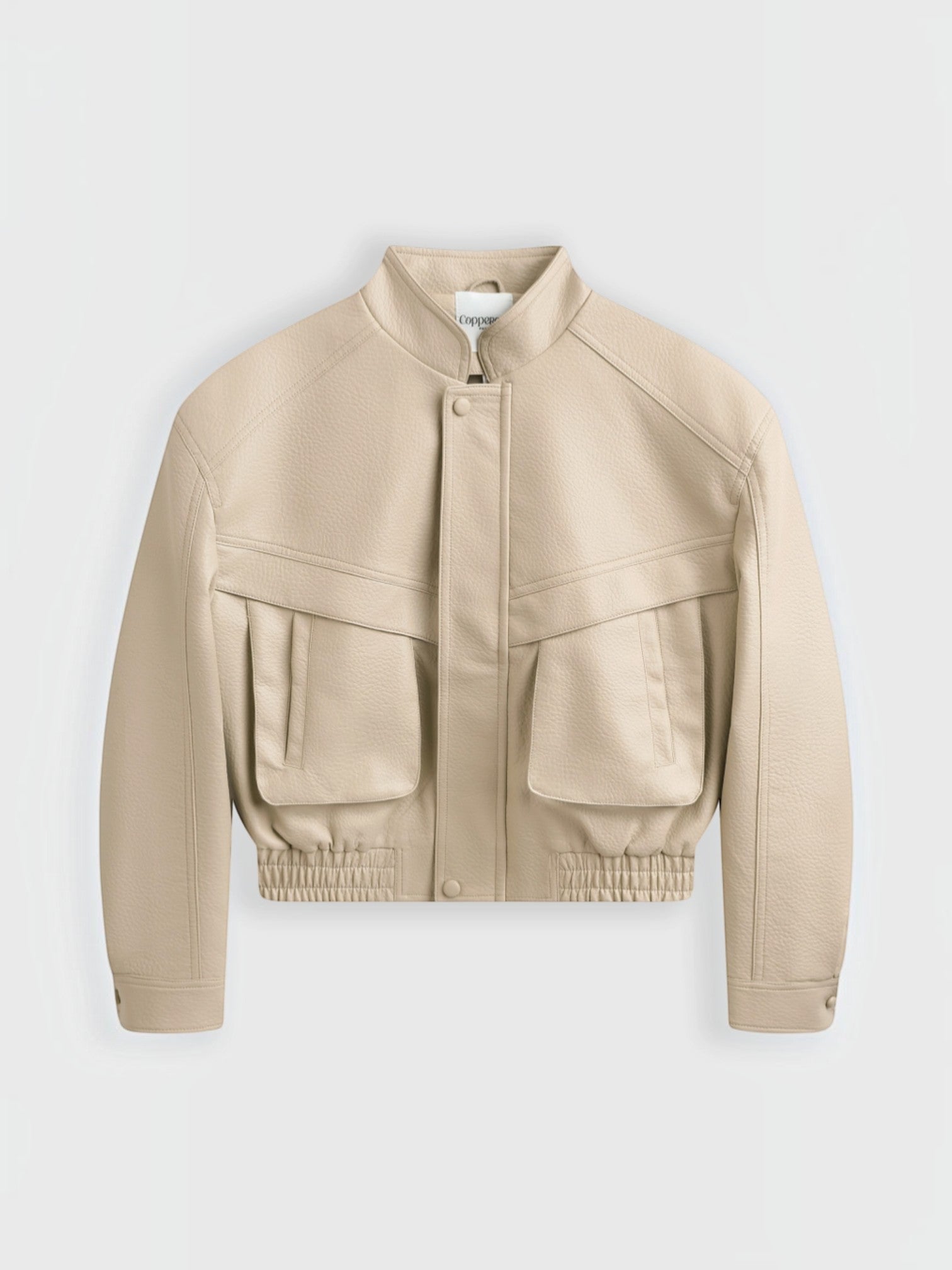 BROCK Copperose beige faux leather cropped jacket with structured shoulders, mandarin collar, and flap pockets.