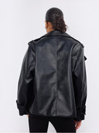 Back view of a BROCK Copperose black faux leather double-breasted jacket with shoulder epaulettes on a model.