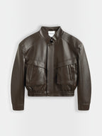 BROCK Copperose chocolate brown faux leather cropped jacket with structured shoulders, mandarin collar, and pockets.