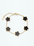 BROCK Éline BYREN | ÉLINE L'ATELIER gold-tone stainless steel bracelet with five black clover-shaped charms.