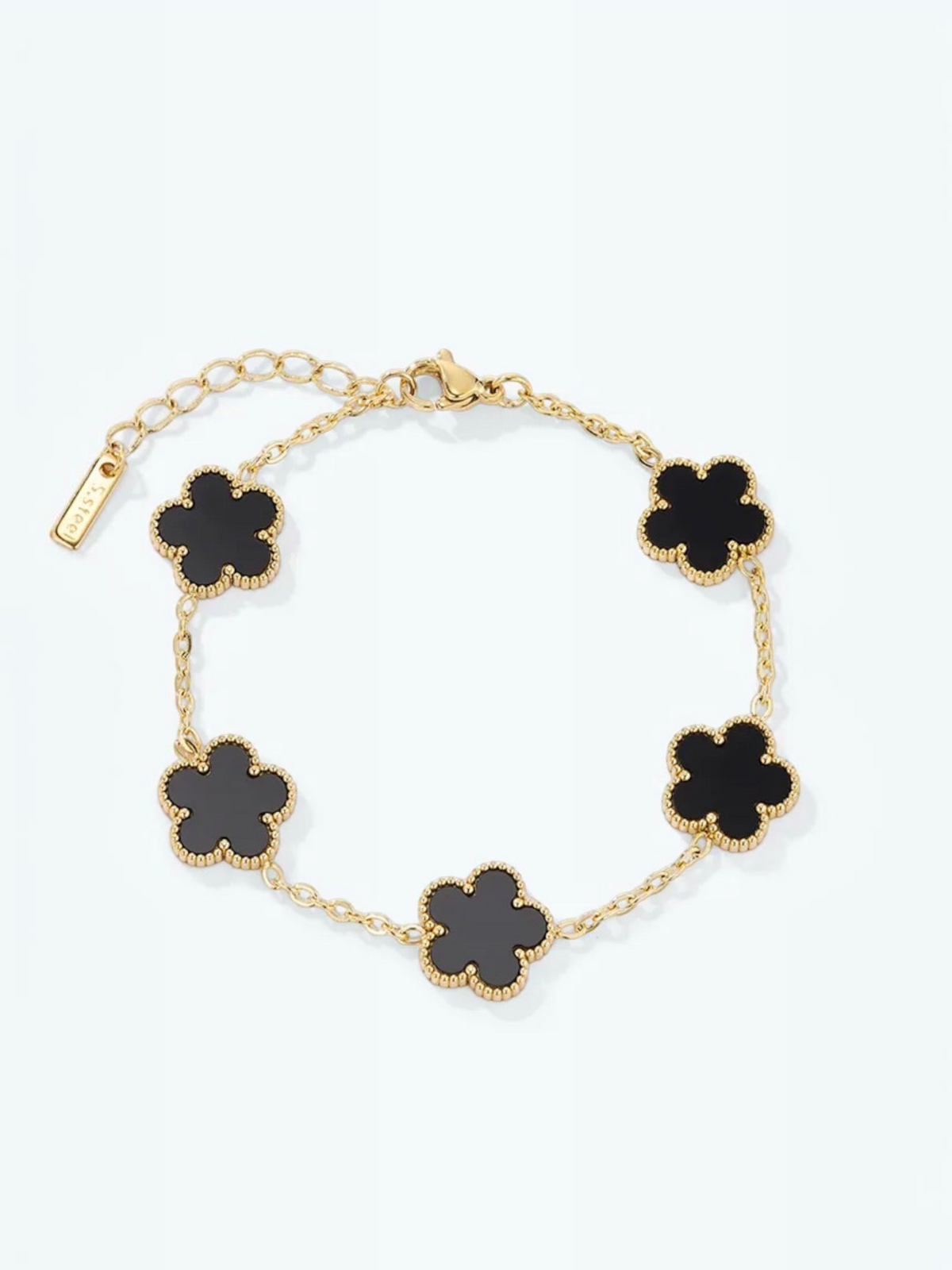 BROCK Éline BYREN | ÉLINE L'ATELIER gold-tone stainless steel bracelet with five black clover-shaped charms.