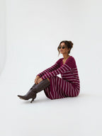 BROCK EMMA & ASHLEY long sleeve striped maxi dress with V-neck worn by a woman with brown boots on a white background